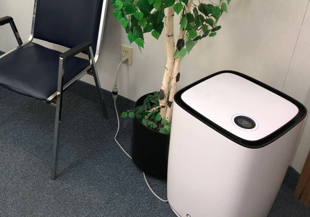 Large industrial air purifier sitting on the floor of the waiting room