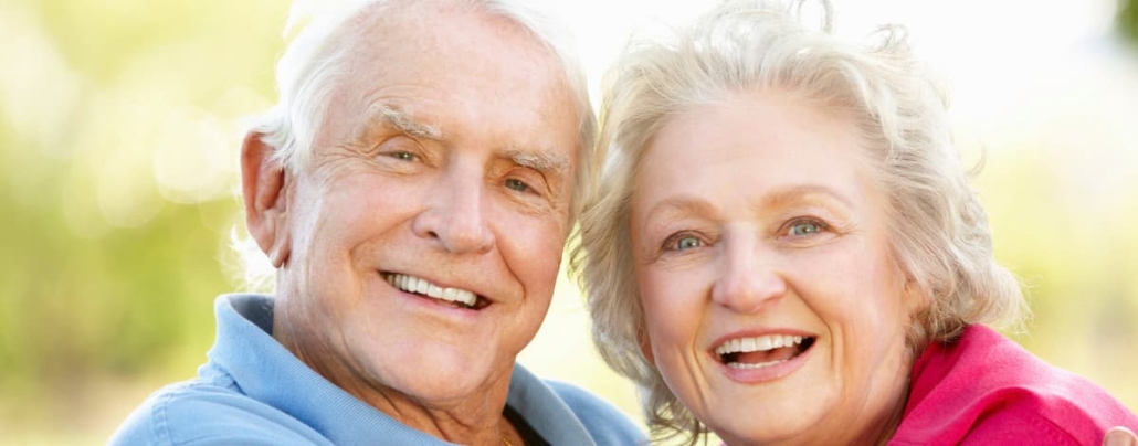 Really happy-looking, smiling grey-haired elderly couple